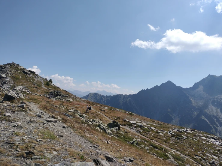 a person walks along the side of a mountain