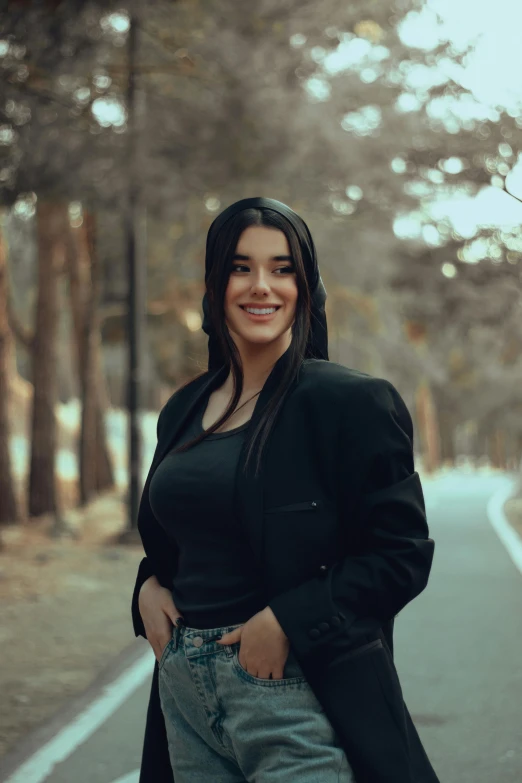 a woman with long hair standing on the road