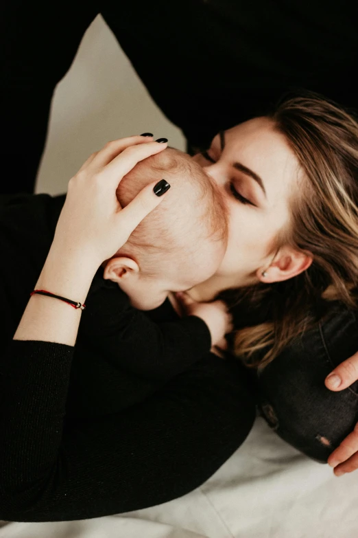 a woman lying on a bed next to a man