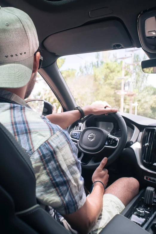 the man is driving the car with his feet on the steering wheel