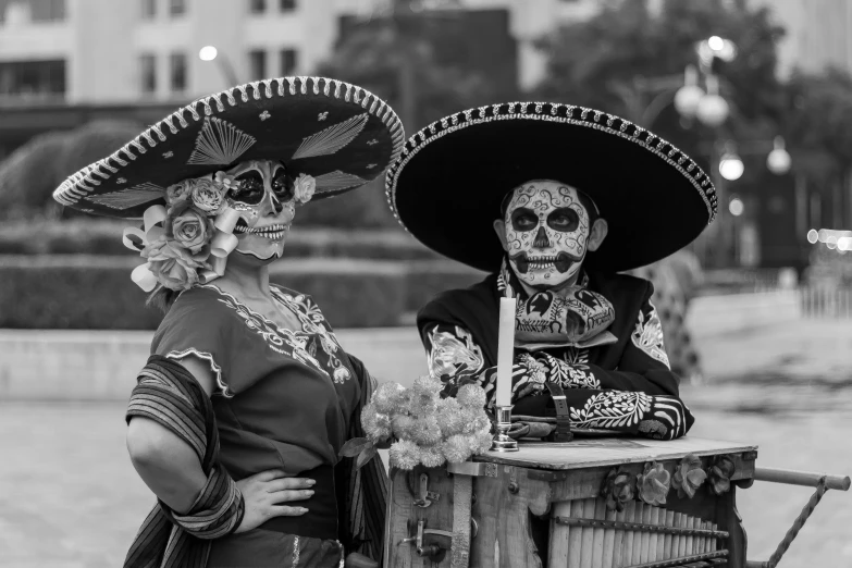 two women with mexican skeleton make up are outside