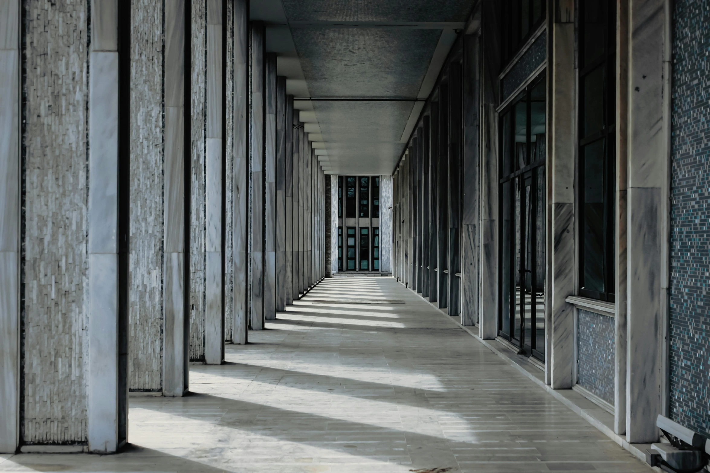 a long hallway lined with wooden boards and shutters