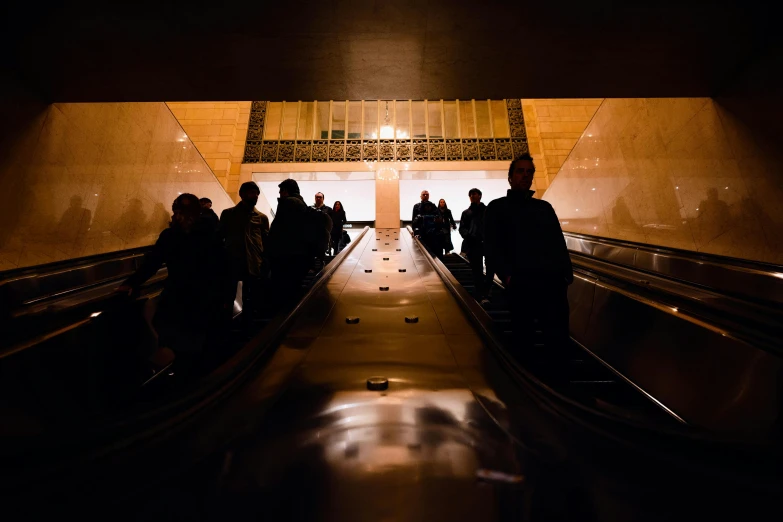 people are traveling down an escalator with a lift up