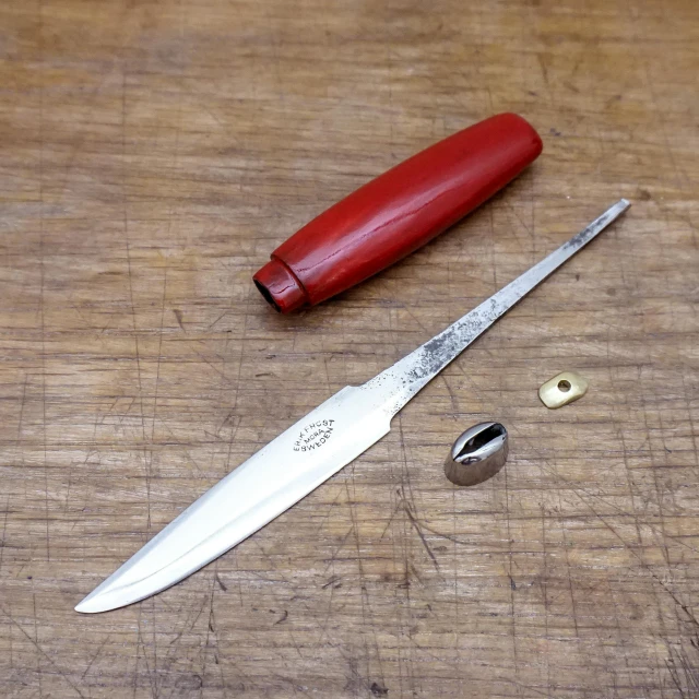 the knife on the  board is next to the cutter