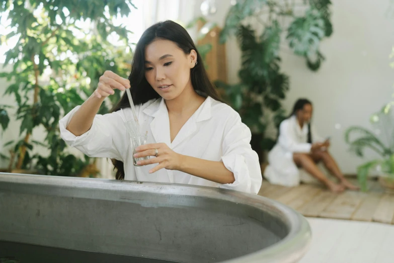 a woman is in a bath tub with flowers