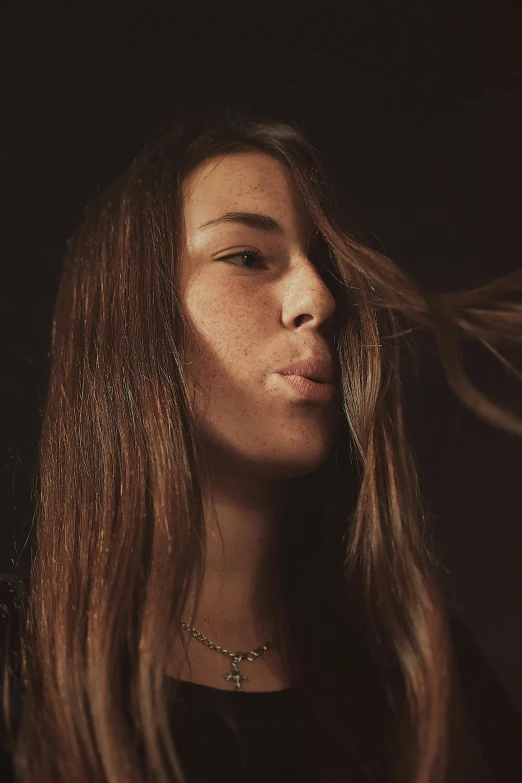 a close up of a woman's face in a dark background