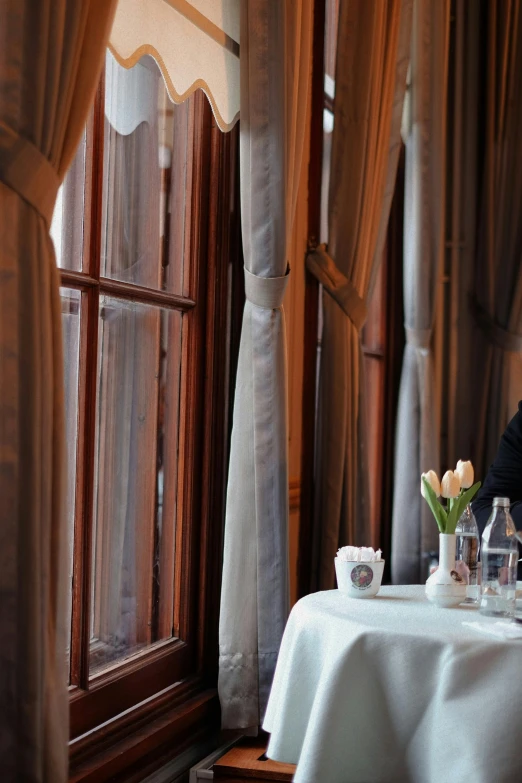 woman looking out a window at the restaurant table