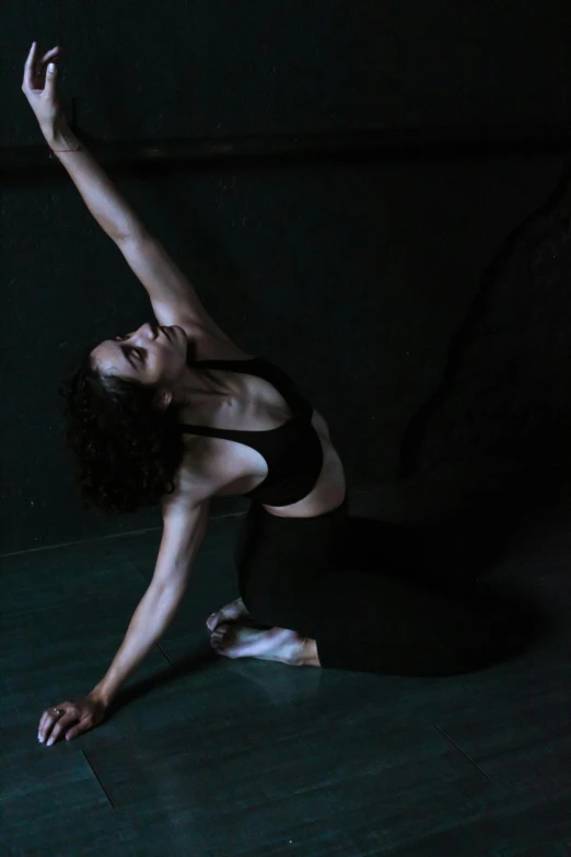 a woman with dark hair is doing yoga