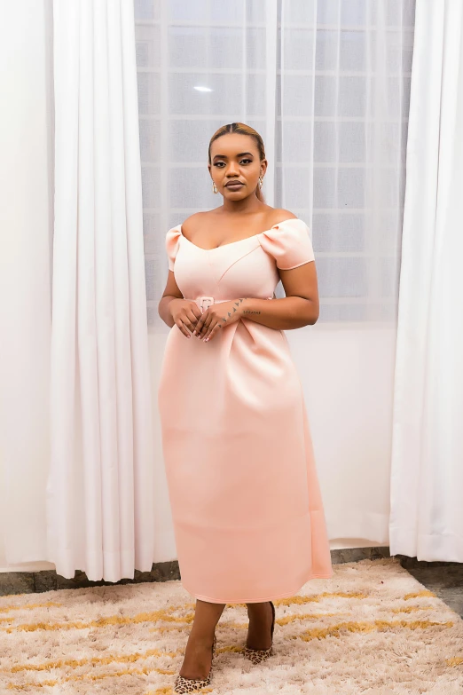 a woman in a pink dress posing for the camera