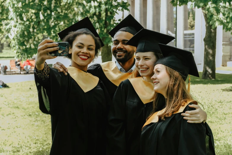 the three students are taking pictures with their phones