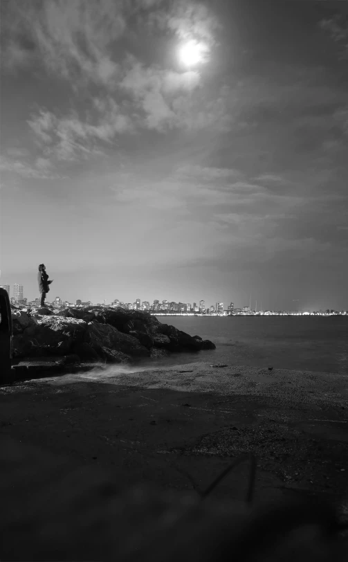 a black and white po of the shoreline on a cloudy day