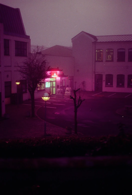 an image of a building with purple light at night