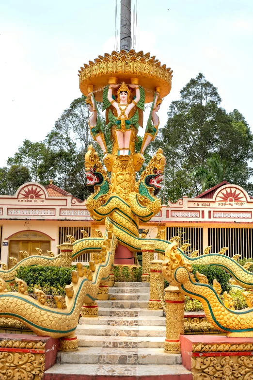 statues in front of a pillar and stairs