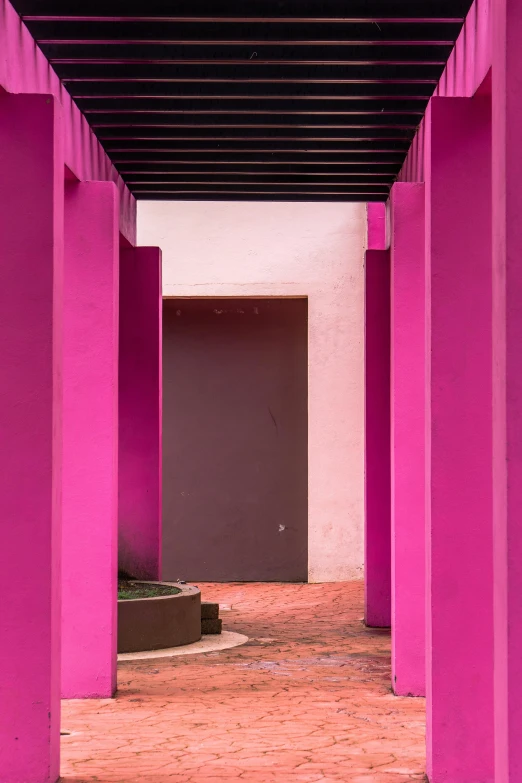 a pink hallway with a brown door under some awnings