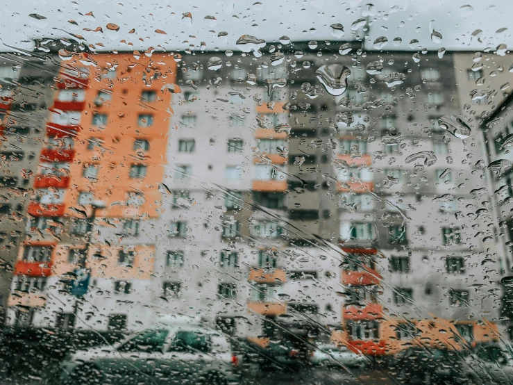 a tall building next to a city on a rainy day