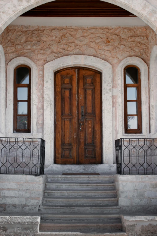 a large wooden door with three small windows