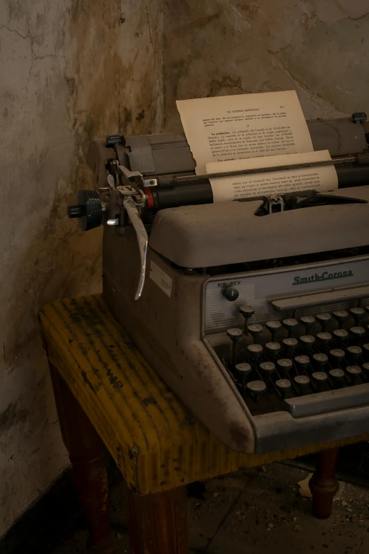 a old typewriter sitting on top of a wooden bench