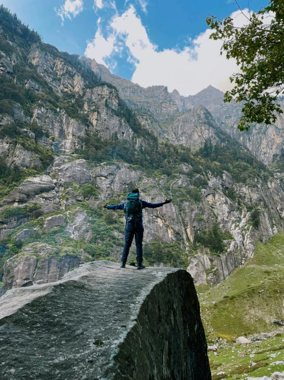 there is a man standing on the edge of a rock