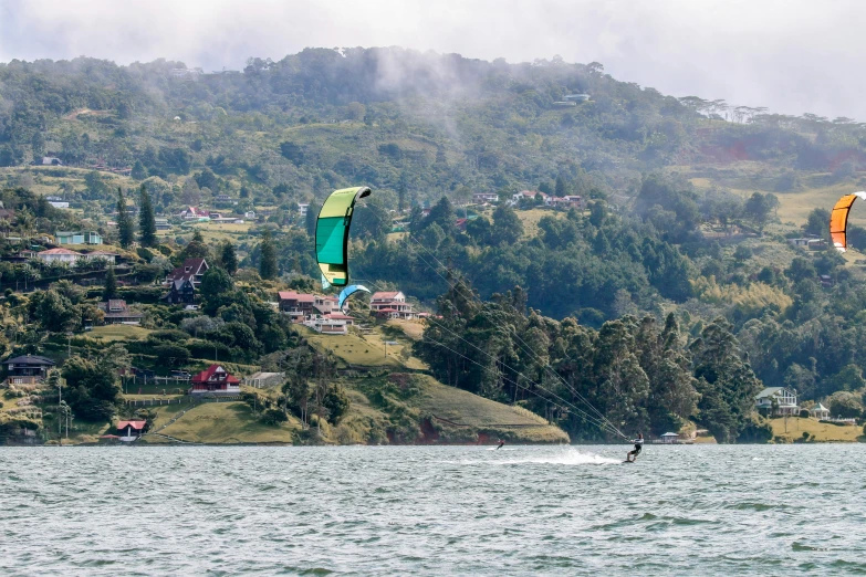 two people para sailing near a hilly mountain area