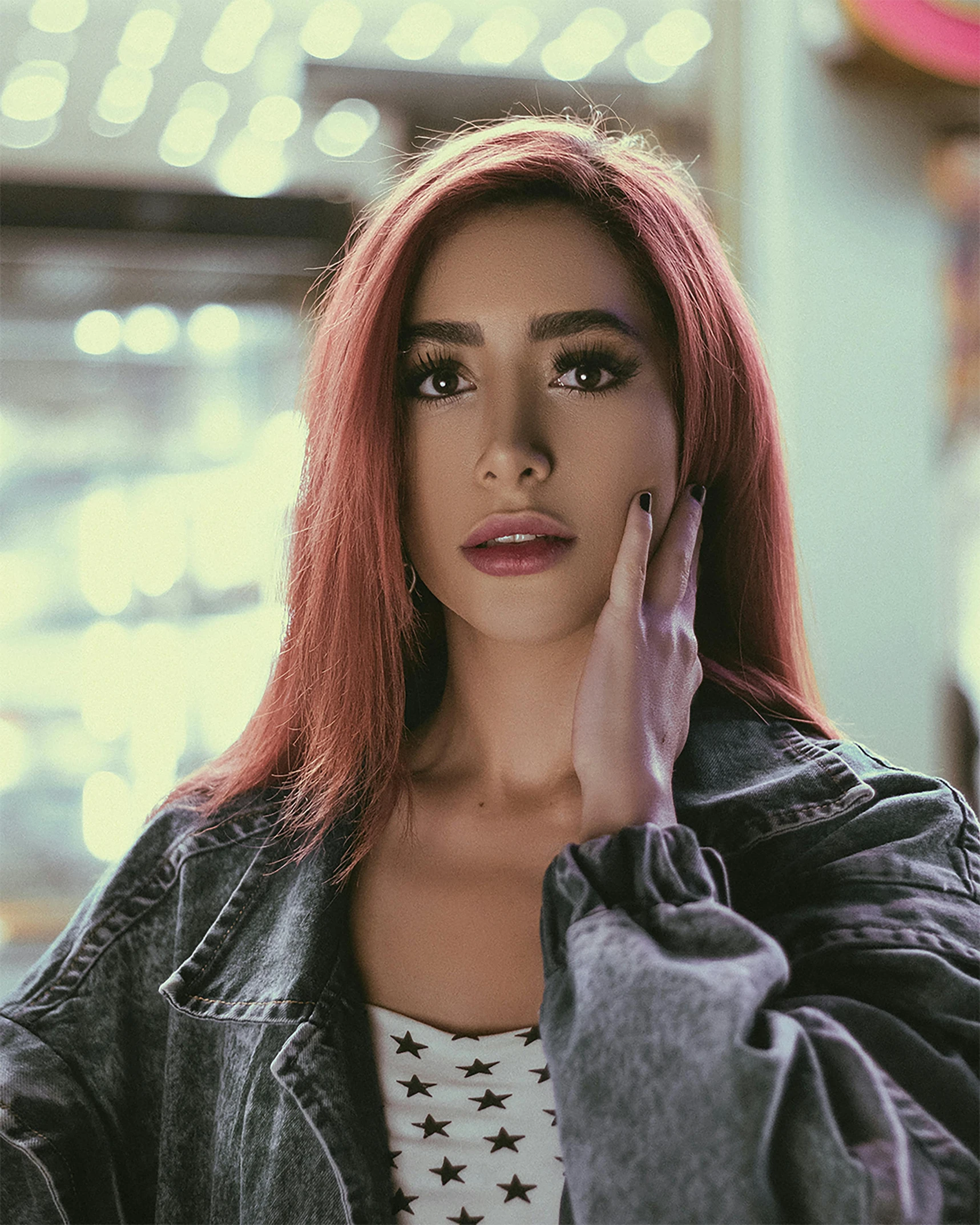 a woman with red hair and stars on her shirt