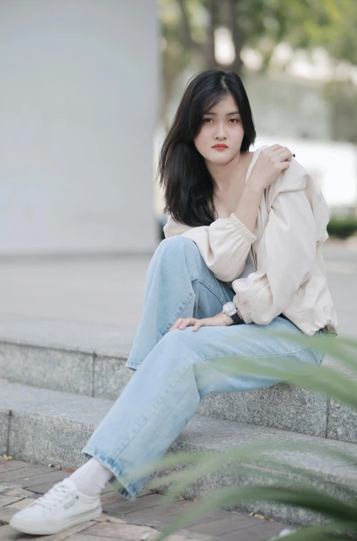 a woman sitting down with a shirt over her shoulder