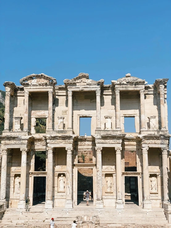 people standing in front of an old building with no doors