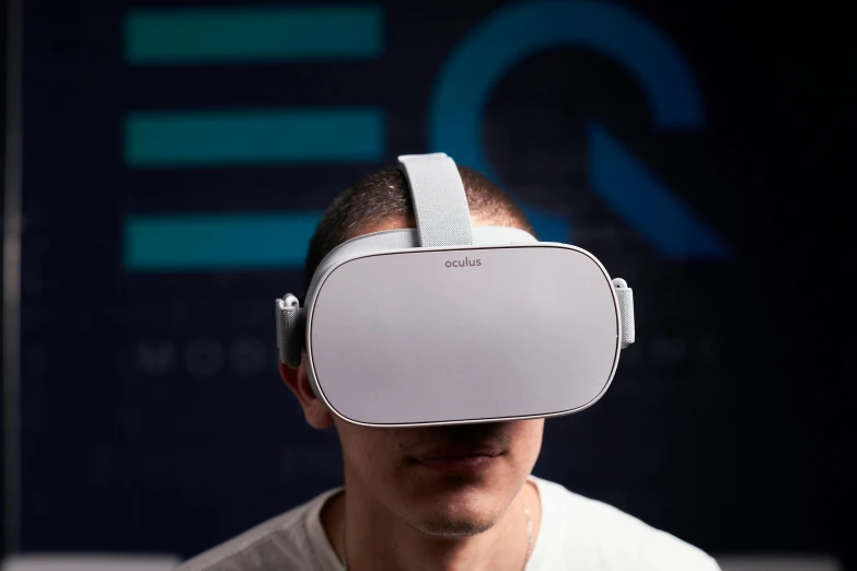 a man wearing the virtual reality glasses while holding up his hands