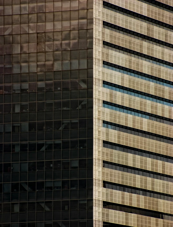 two brown buildings side by side with a red building