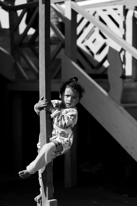 a woman climbing a rope on the outside of a house