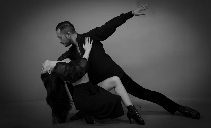 a man and woman performing on the floor