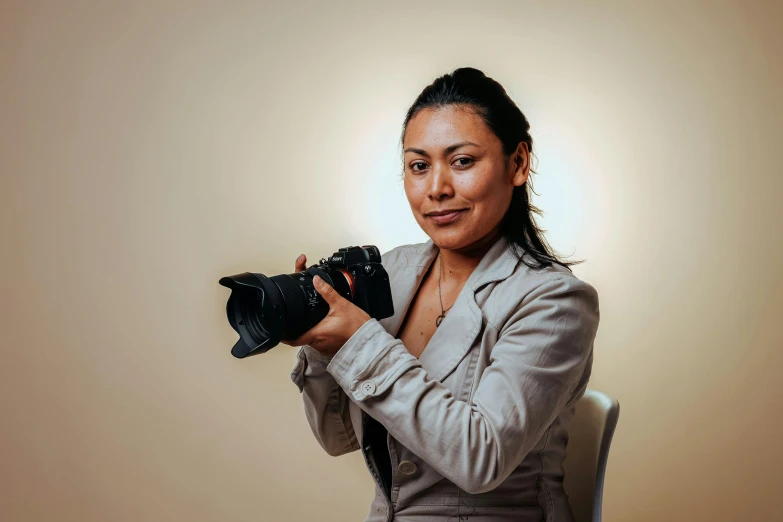 woman posing for po holding camera and smiling