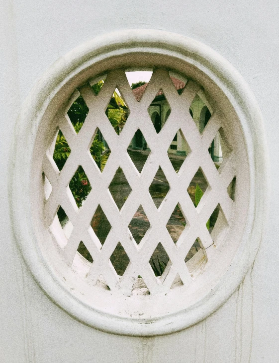 a white and grey window with decorative design