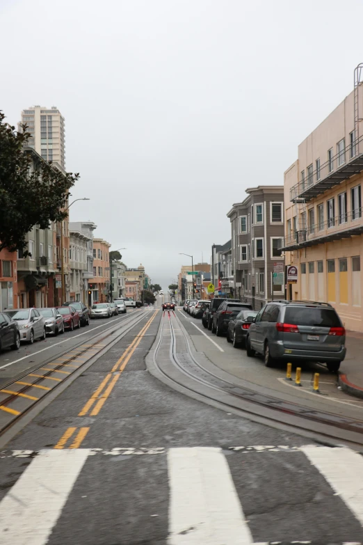 a street with cars and a sign on the road