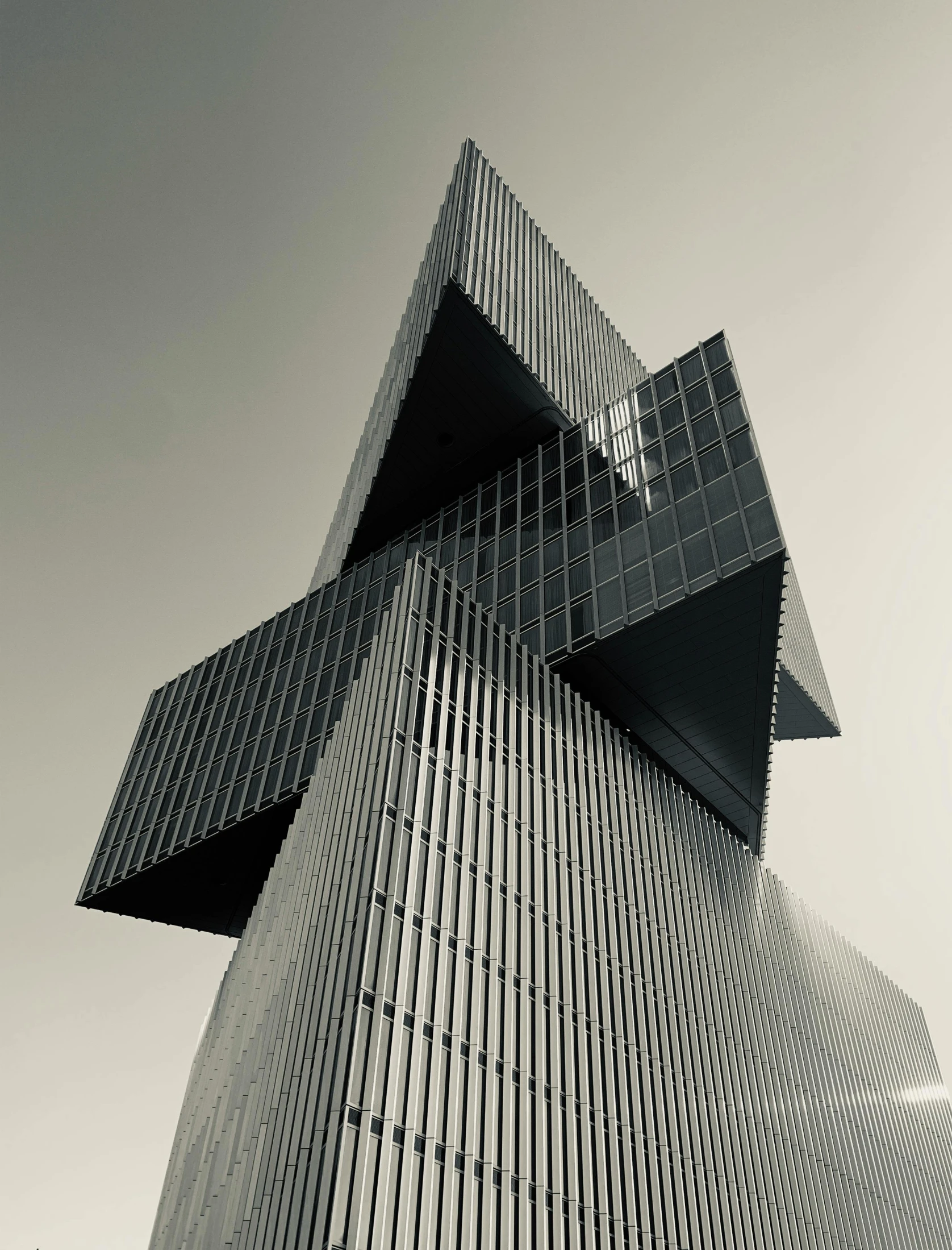 the image is black and white and has a building designed like a cross