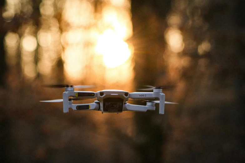 a camera filming a pair of djrobots flying above trees