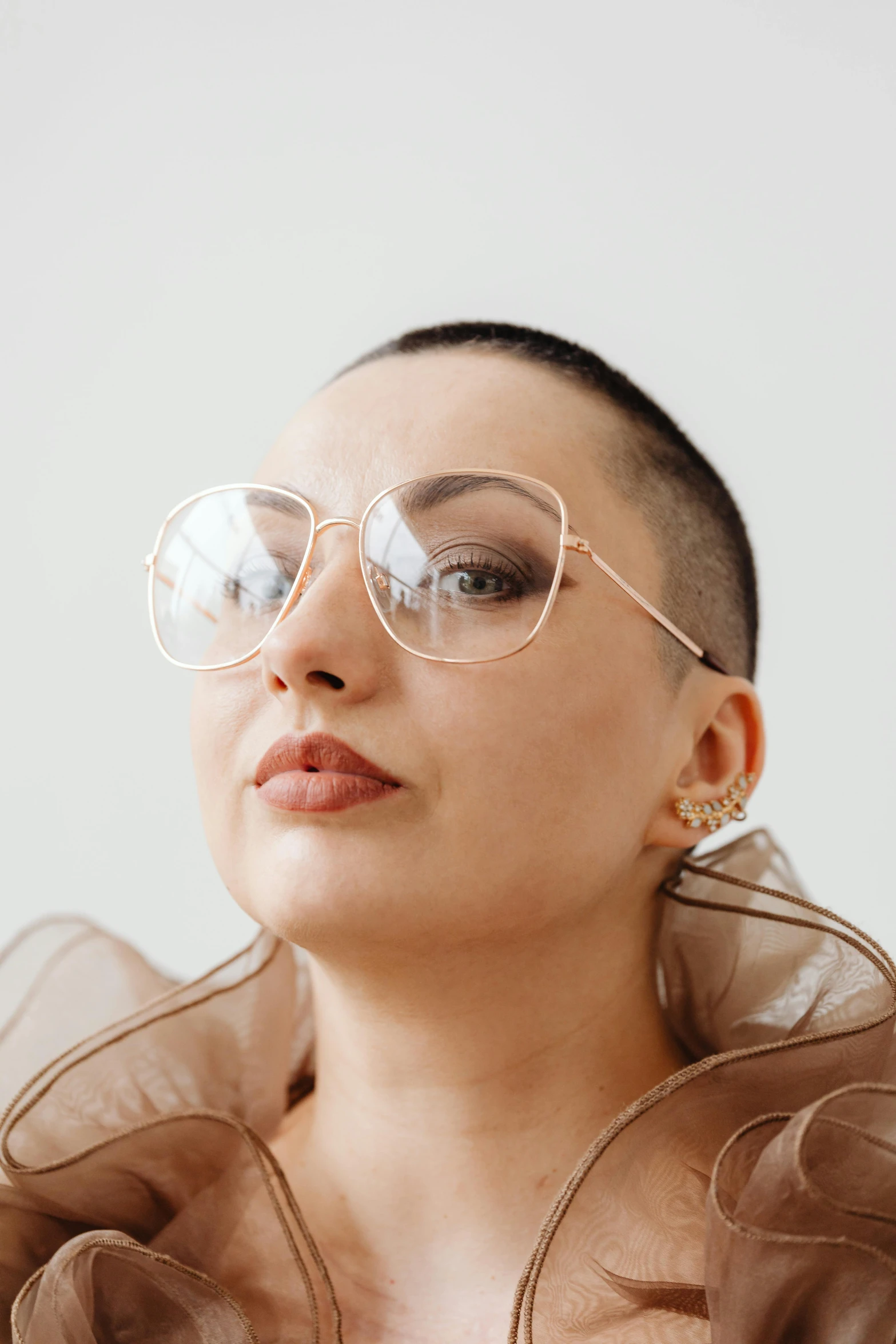 woman wearing glasses with brown frilles and light up makeup