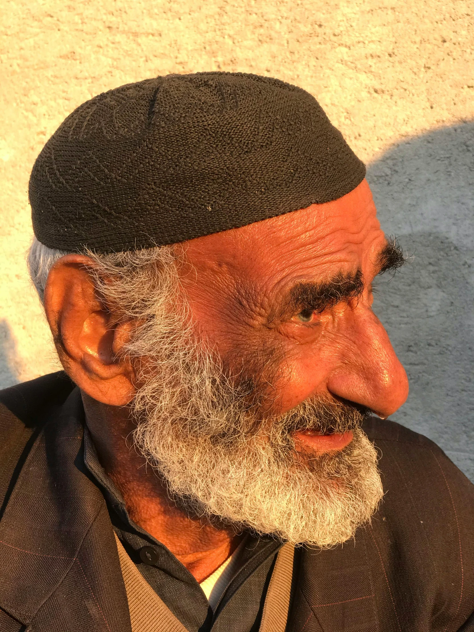 a man with a beard and a white cap