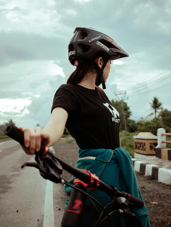 the woman is riding her bike with a helmet on