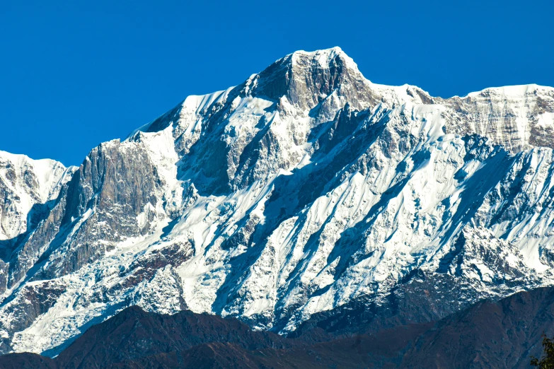 a white mountain in the mountains covered with snow