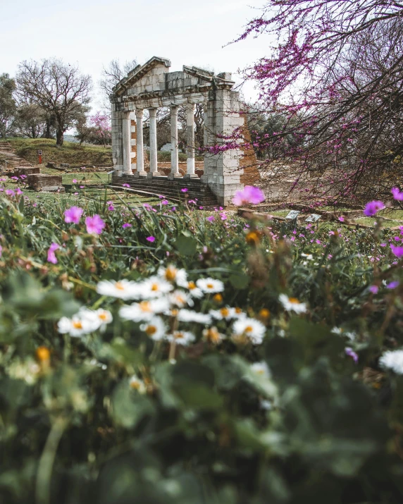 some kind of old building with flowers in front