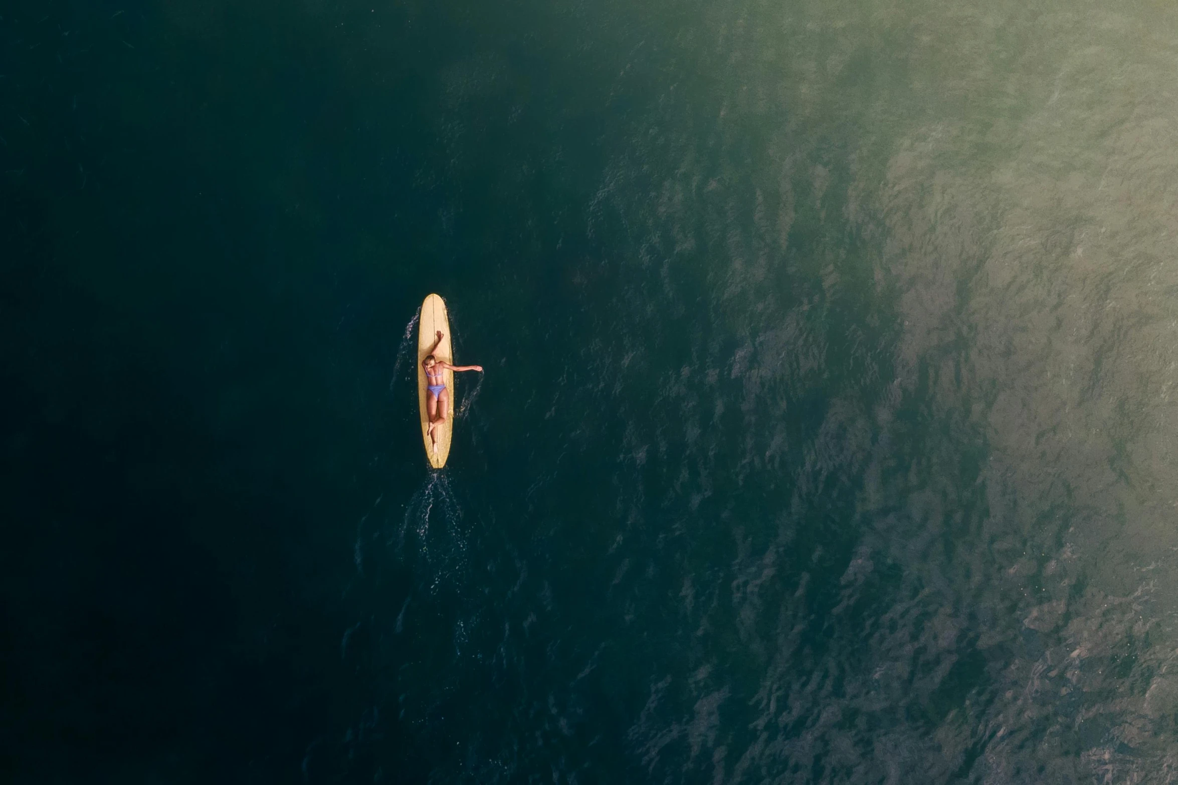 a person riding on a surfboard in the ocean