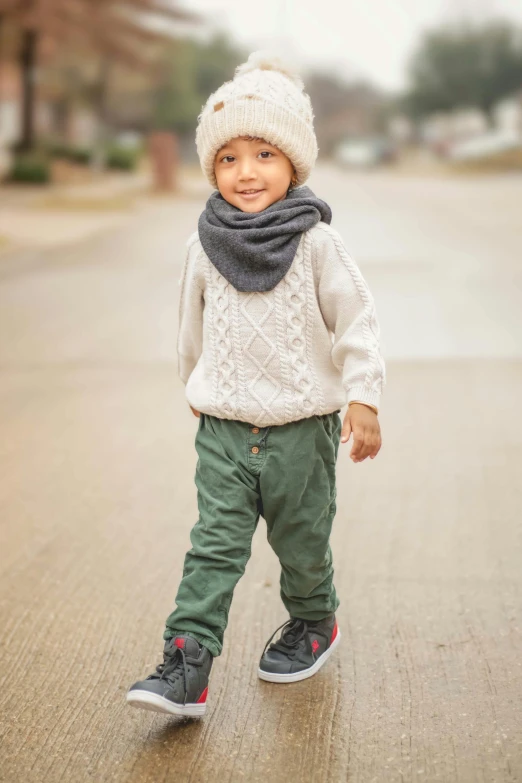 the little child wears a warm knit winter hat