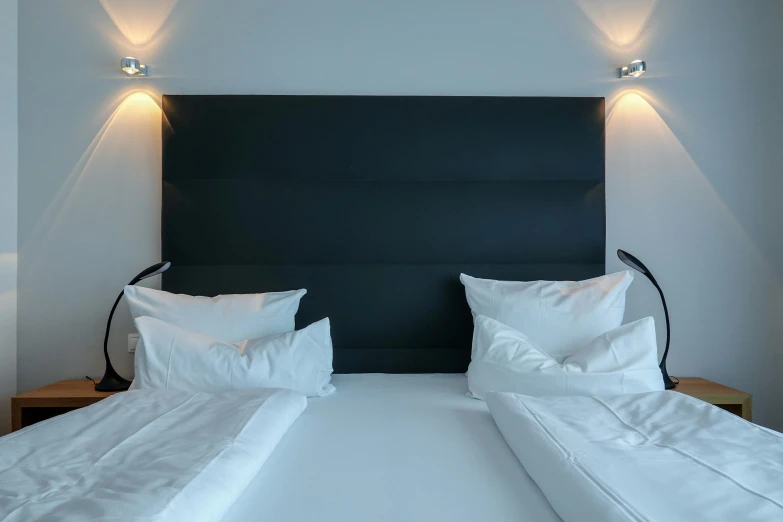 the black headboard against the white sheets and pillows