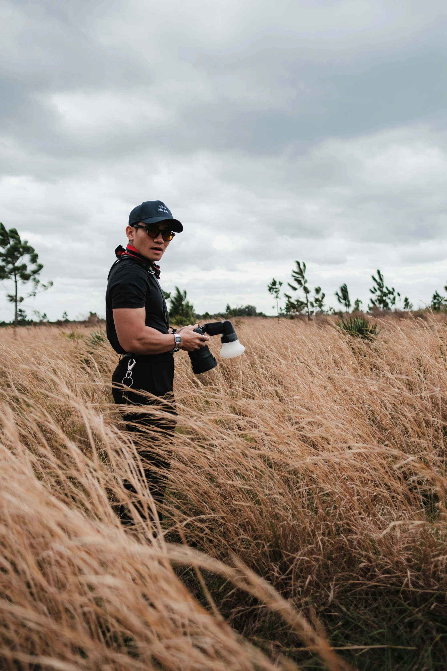 a man standing on top of a dry grass field