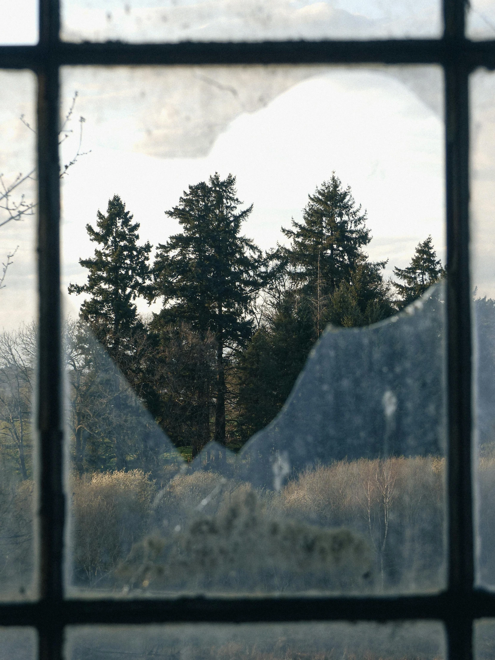 the view of mountains through a window at twilight