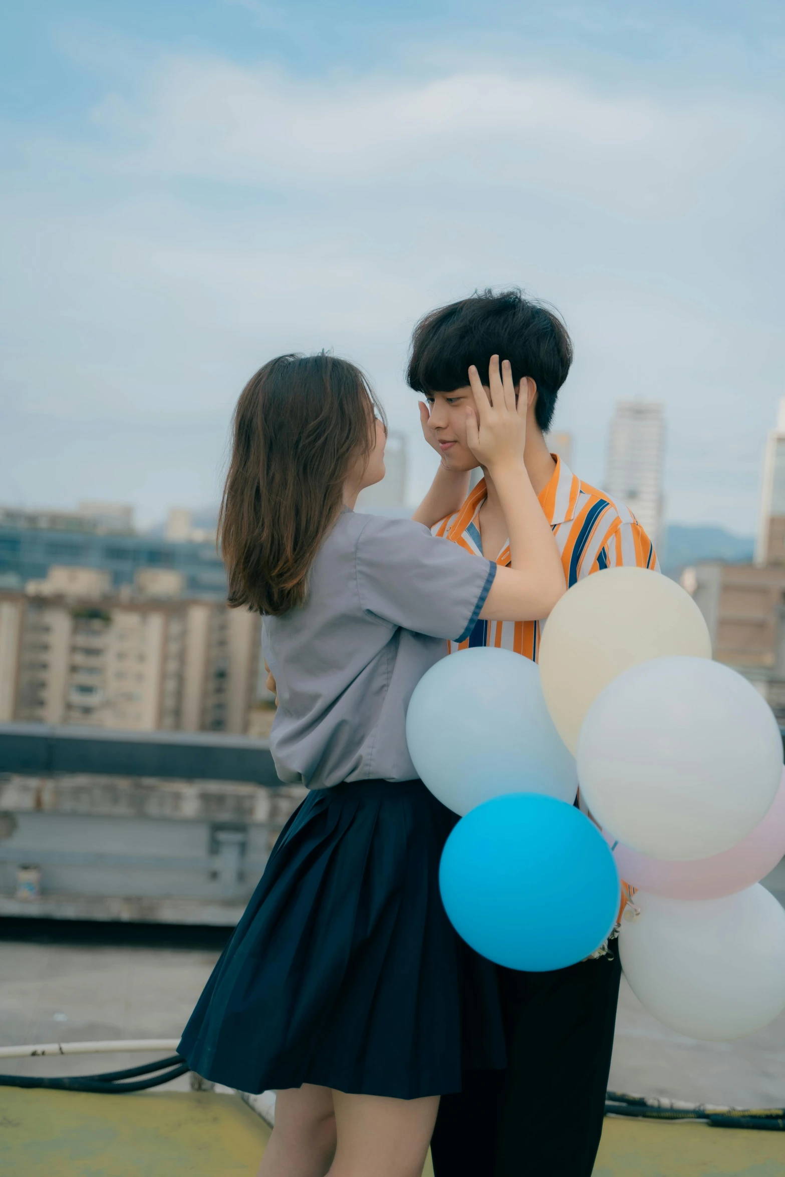 a man standing next to a woman with a bunch of balloons