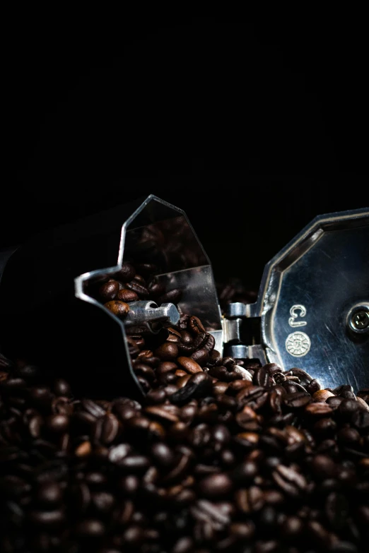 coffee grains and a manual grinder for grinding their beans