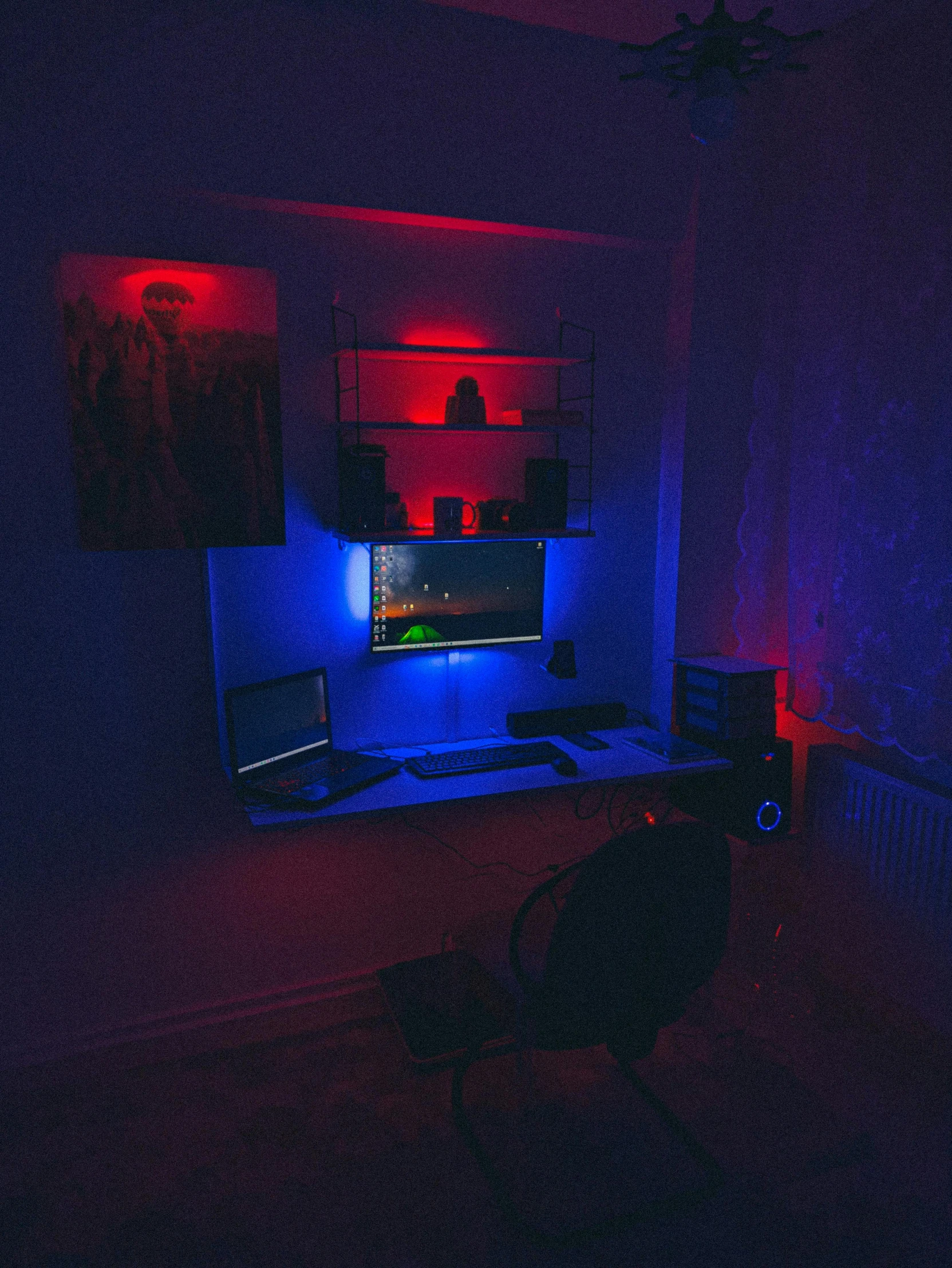 a room with computer monitors, a television and a keyboard in it