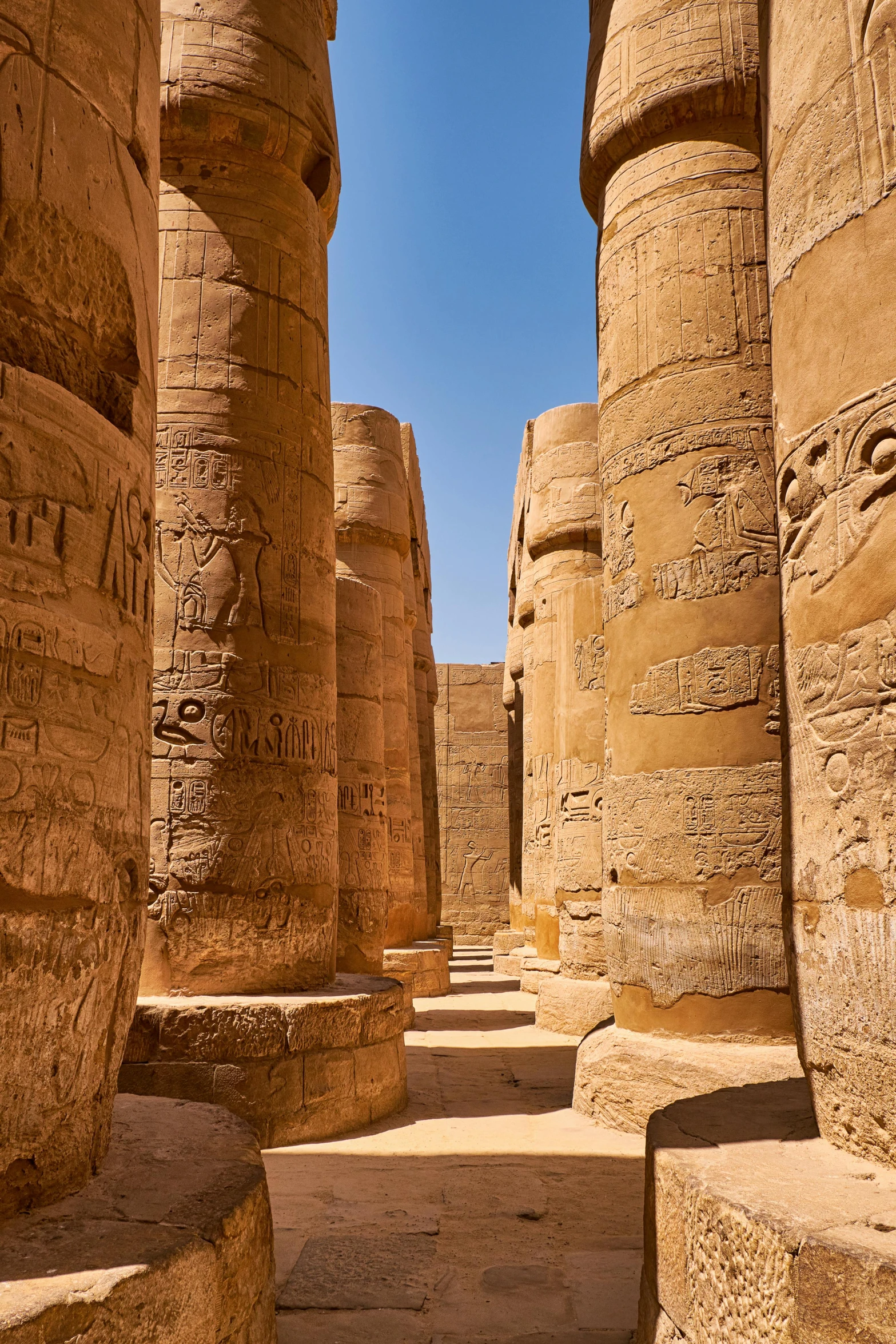 a view into the large corridor at the temple of kot khe on one side and smaller pillars on the other