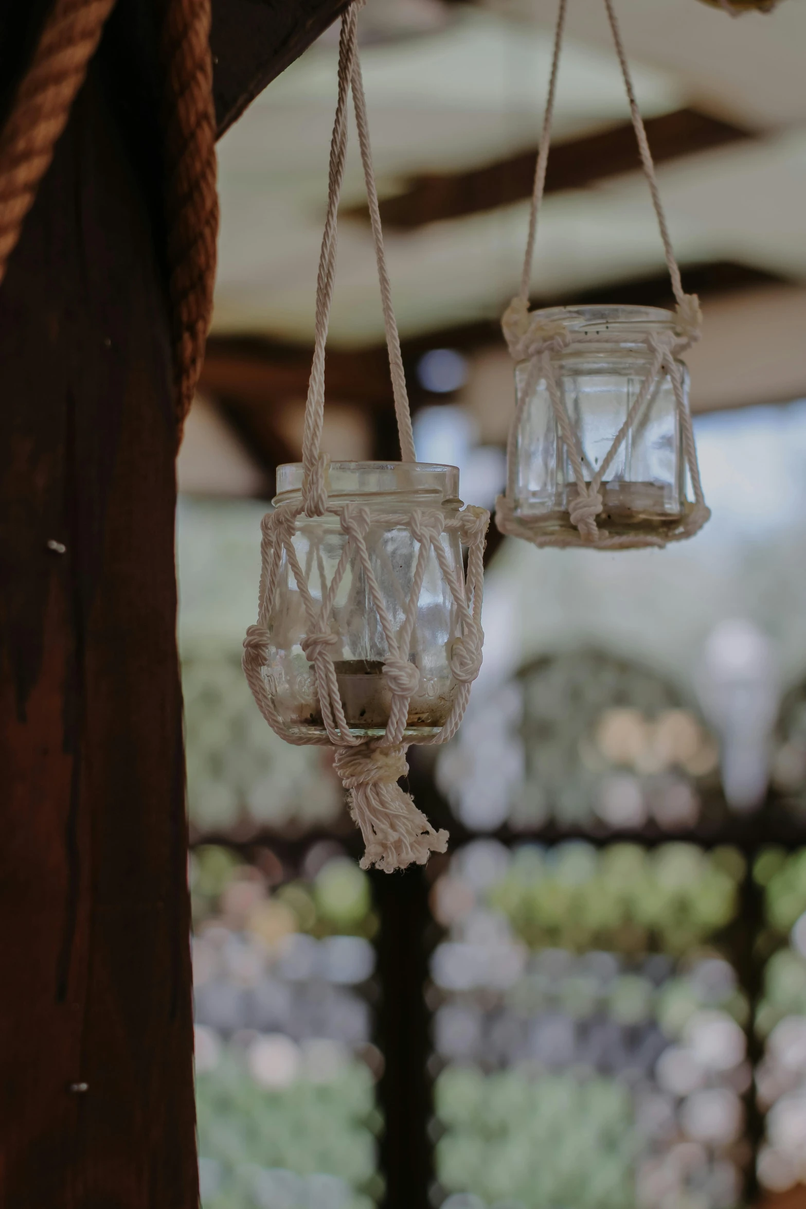 some glasses hanging from the ceiling with a rope